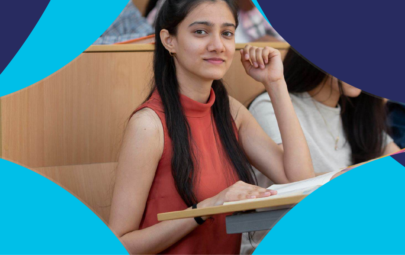Student smiling while studying at a desk